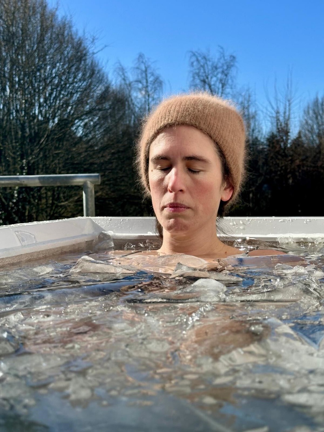 Woman in an ice bath in a frozen tub